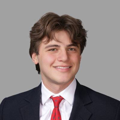 Image 1 of 2 Person wearing black suit smiling